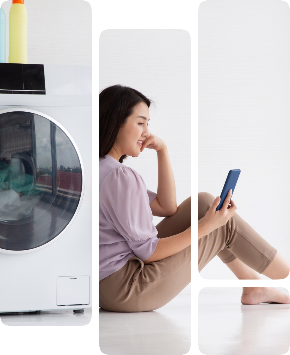 Woman using smartphone near washing machine.